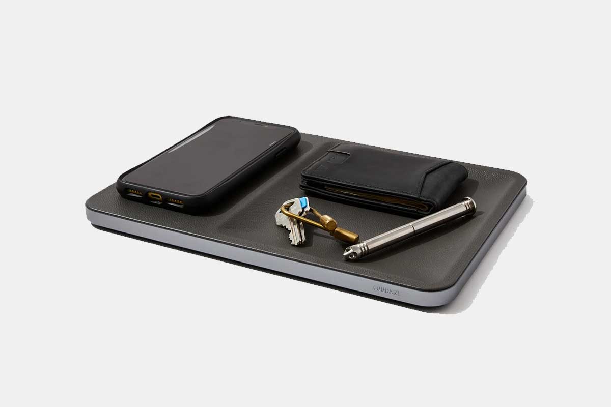 The Courant Catch:3 wireless charging tray, holding a phone, keys, wallet and pen