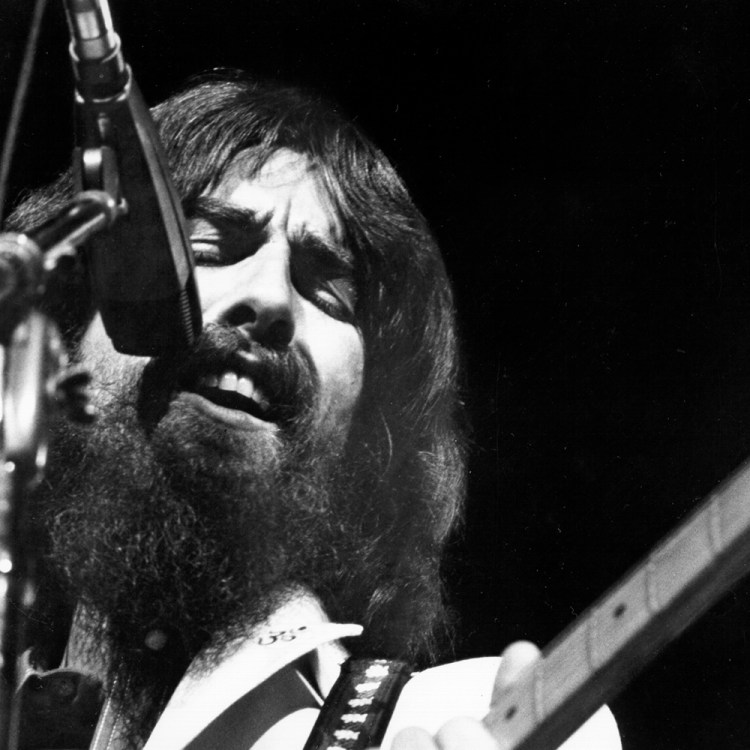 George Harrison performs onstage at the Concert for Bangladesh which was held at Madison Square Garden on August 1, 1971 in New York City