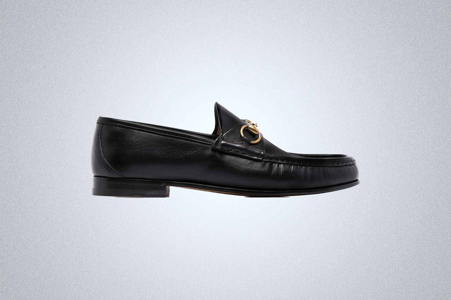 A pair of Summer Loafers from Gucci on a grey background
