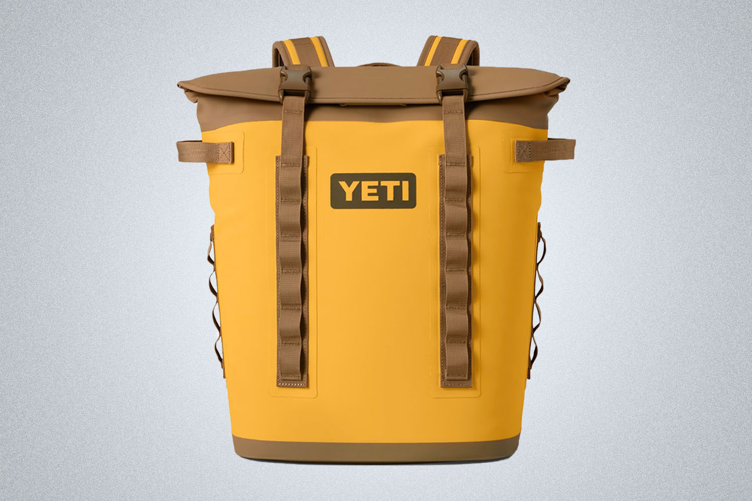 a yellow and orange cooler backpack from YETI on a grey background