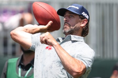 Aaron Rodgers throws a football at the American Century Championship.  