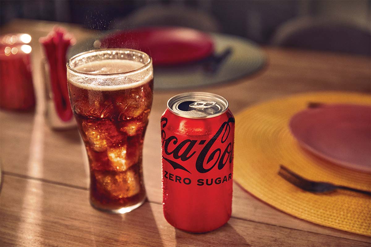 A glass and a can of new Coca-Cola Zero Sugar on a table