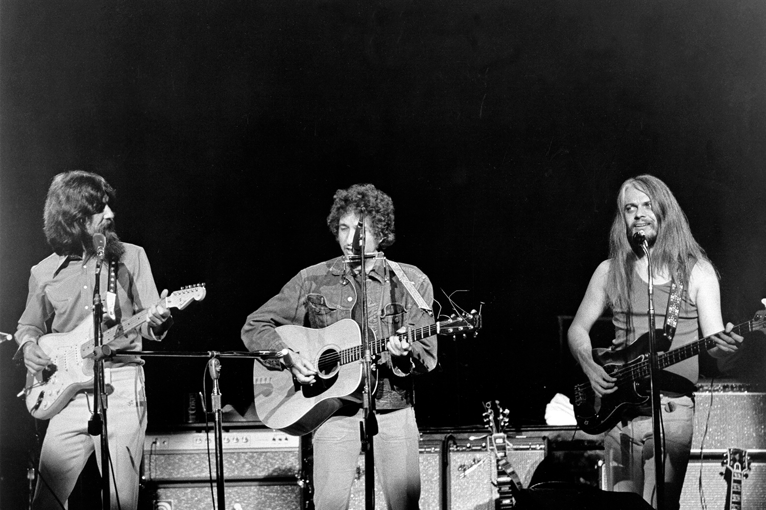 George Harrison, Bob Dylan and Leon Russell perform onstage