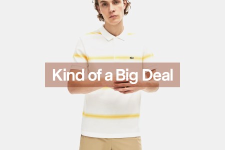 Model in white and yellow striped Lacoste Polo