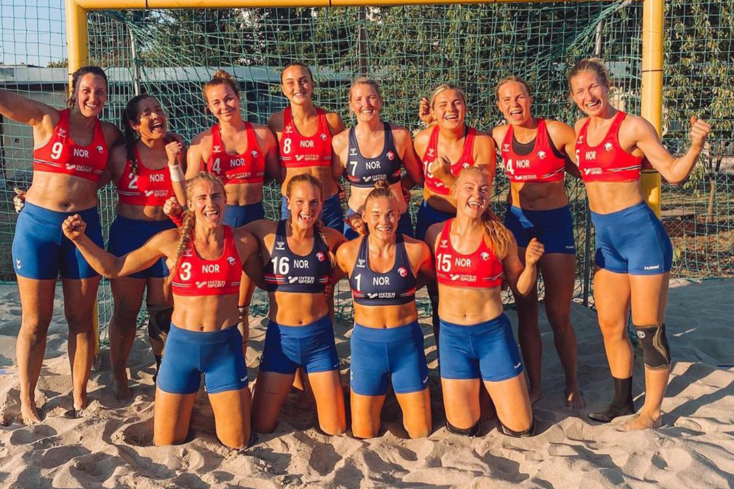 norway women's handball team poses for a group photo in sports bras and shorts