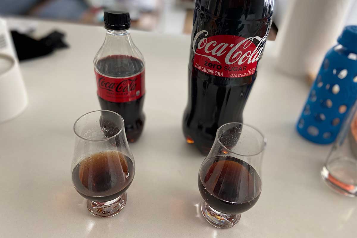tasting glasses and bottles of new vs. old Coca-Cola Zero Sugar