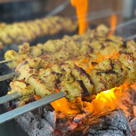 Roya's Persian chicken kabobs over an open flame