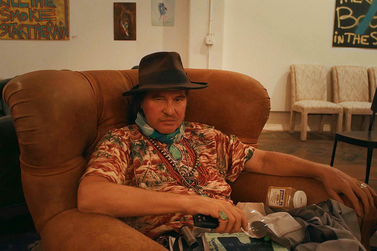 Val Kilmer sitting down in the documentary "Val", which was built from video the actor took over several decades