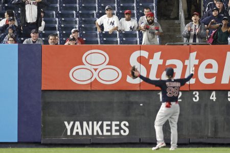 Alex Verdugo gestures towards the stands after being hit with a baseball. 