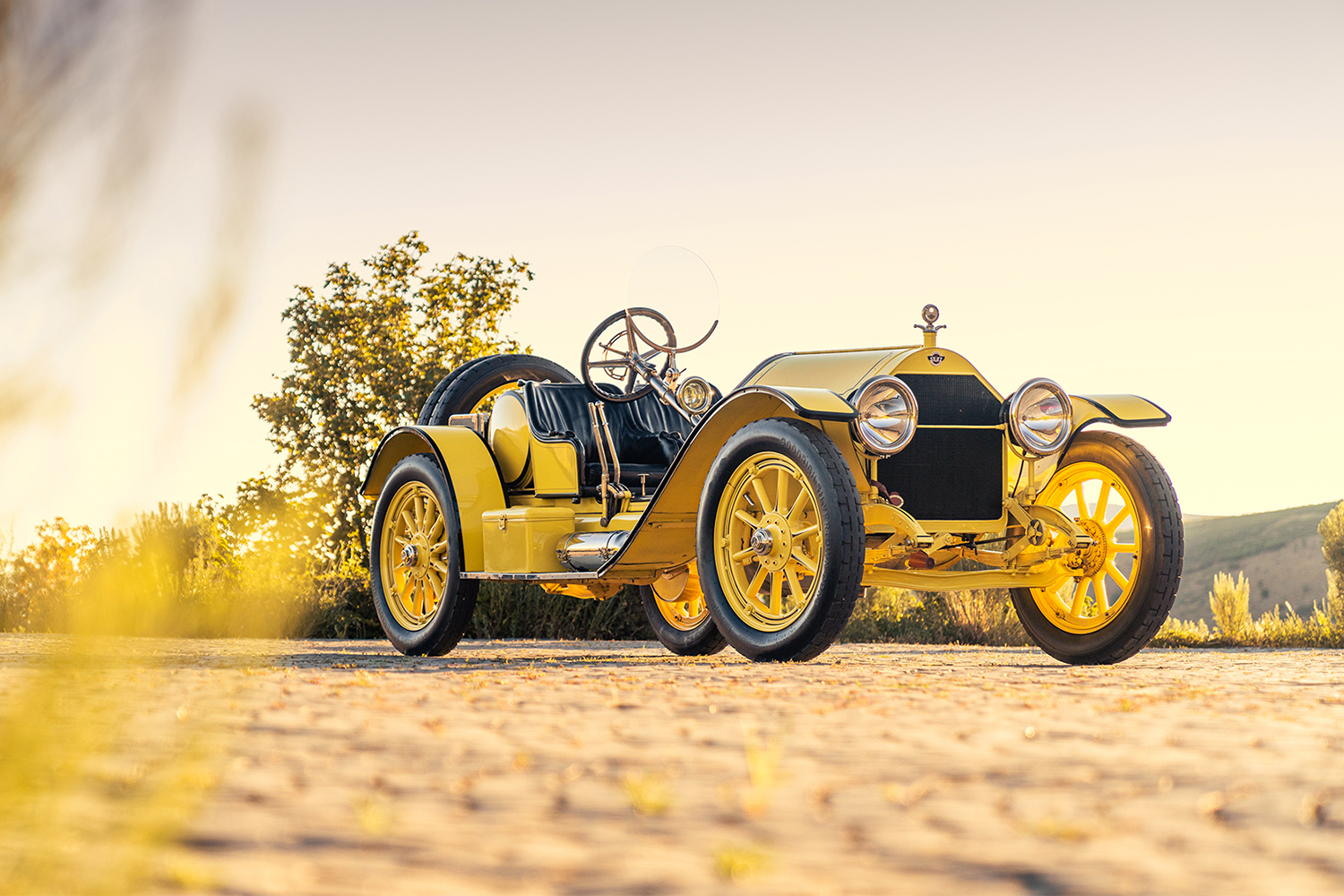 A yellow and black 1914 Stutz 4E Bearcat, a Brass Era sports car heading to auction at Pebble Beach via Gooding & Company