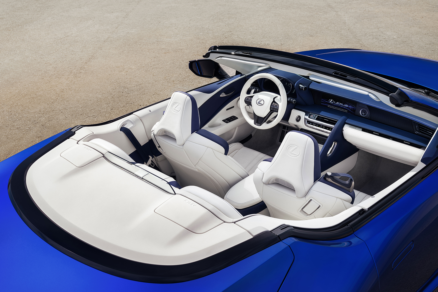 The white interior of a 2021 Lexus LC 500 Convertible in blue. The only thing we don't like about it? The infotainment. 