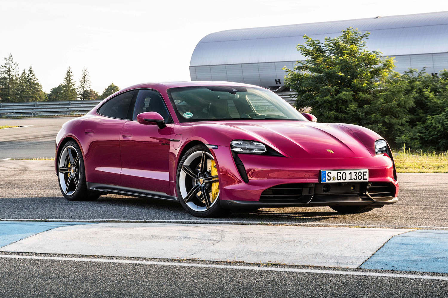 A Porsche Taycan in Rubystone Red. The electric car is newly available in the heritage color, but the more exciting EV news comes from Porsche's partnership with Rimac.