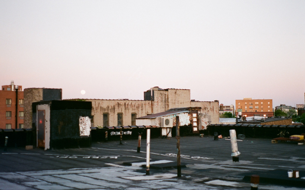 A sleepy Brooklyn rooftop under a rising full moon