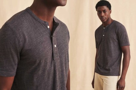 A man wearing Faherty's short-sleeve henley. The men's shirt is on sale for 50% off during the End of Season Sale in August 2021.