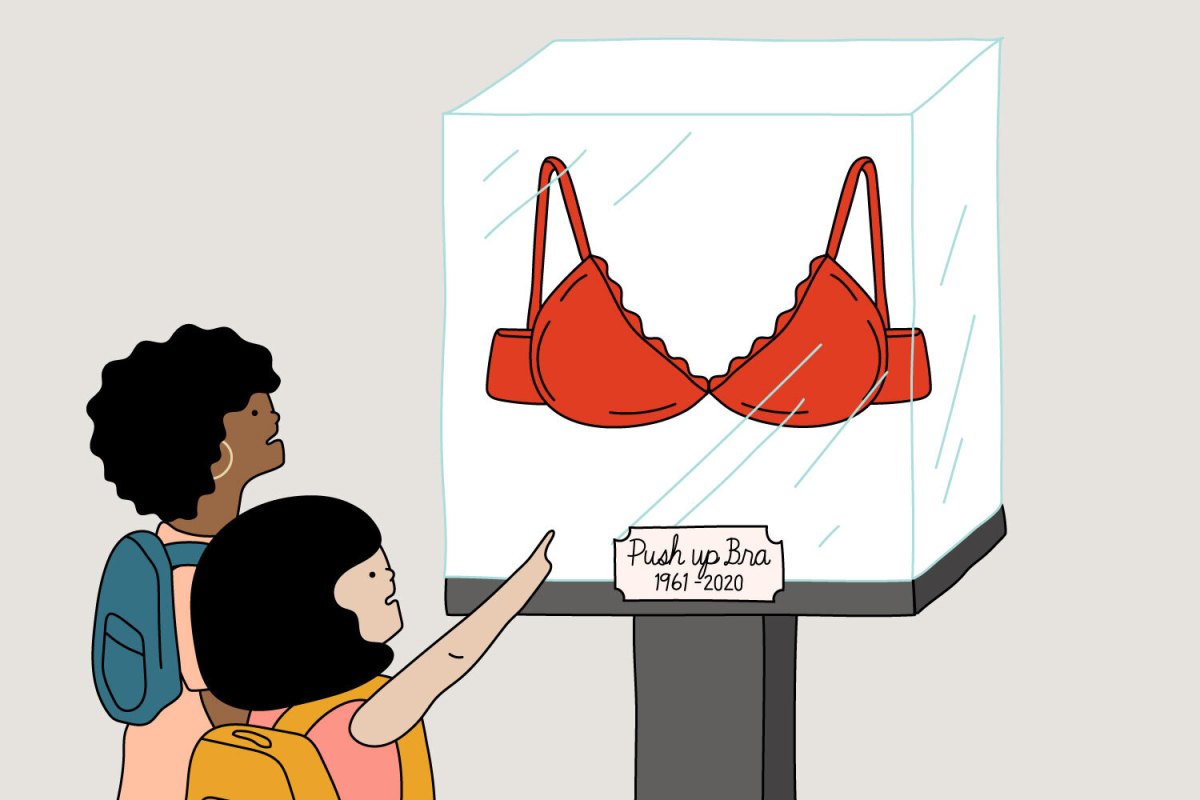 illustration shows two children viewing a push-up bra on display in a glass case at a museum