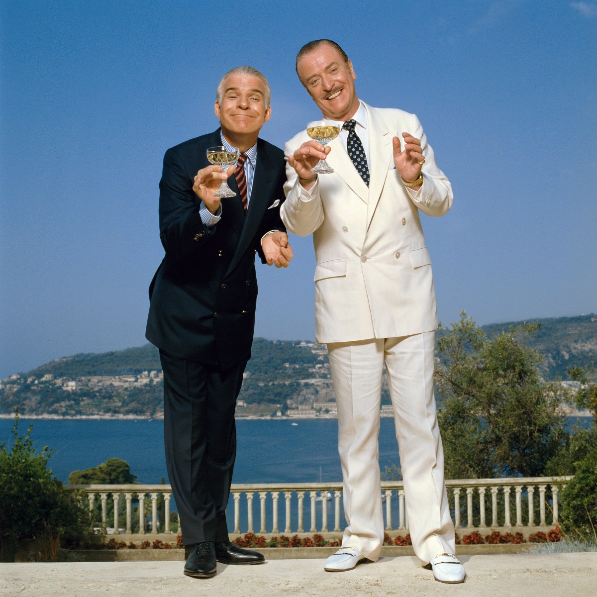 By the late 1980s, Michael Caine was a well-established international movie star, and “Dirty Rotten Scoundrels” was a high point in his Hollywood film career. Here he is with co-star, Steve Martin in 1988. <br><br>By Terry O'Neill, courtesy of ACC Art Books