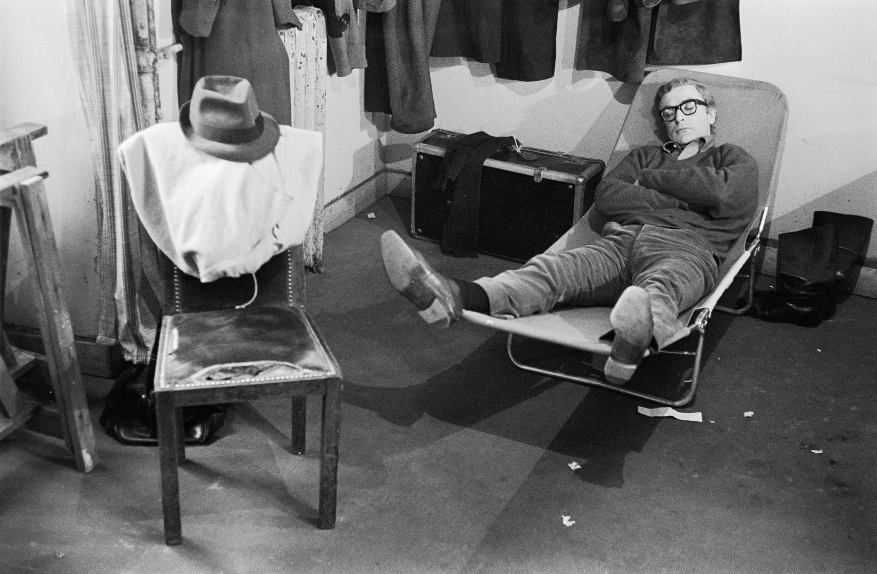 Michael Caine takes a nap during the filming of “Woman Times Seven” by Vittorio De Sica in Paris, 1967. <br><br><meta charset="utf-8">By Terry O'Neill, courtesy of ACC Art Books