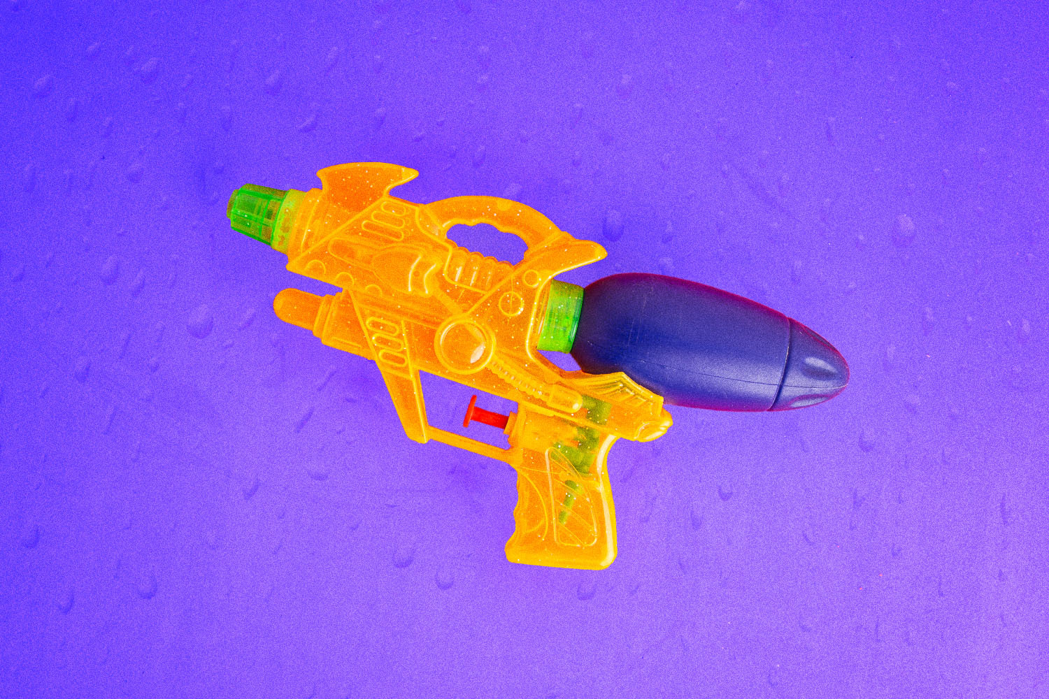 toy squirt gun on purple background