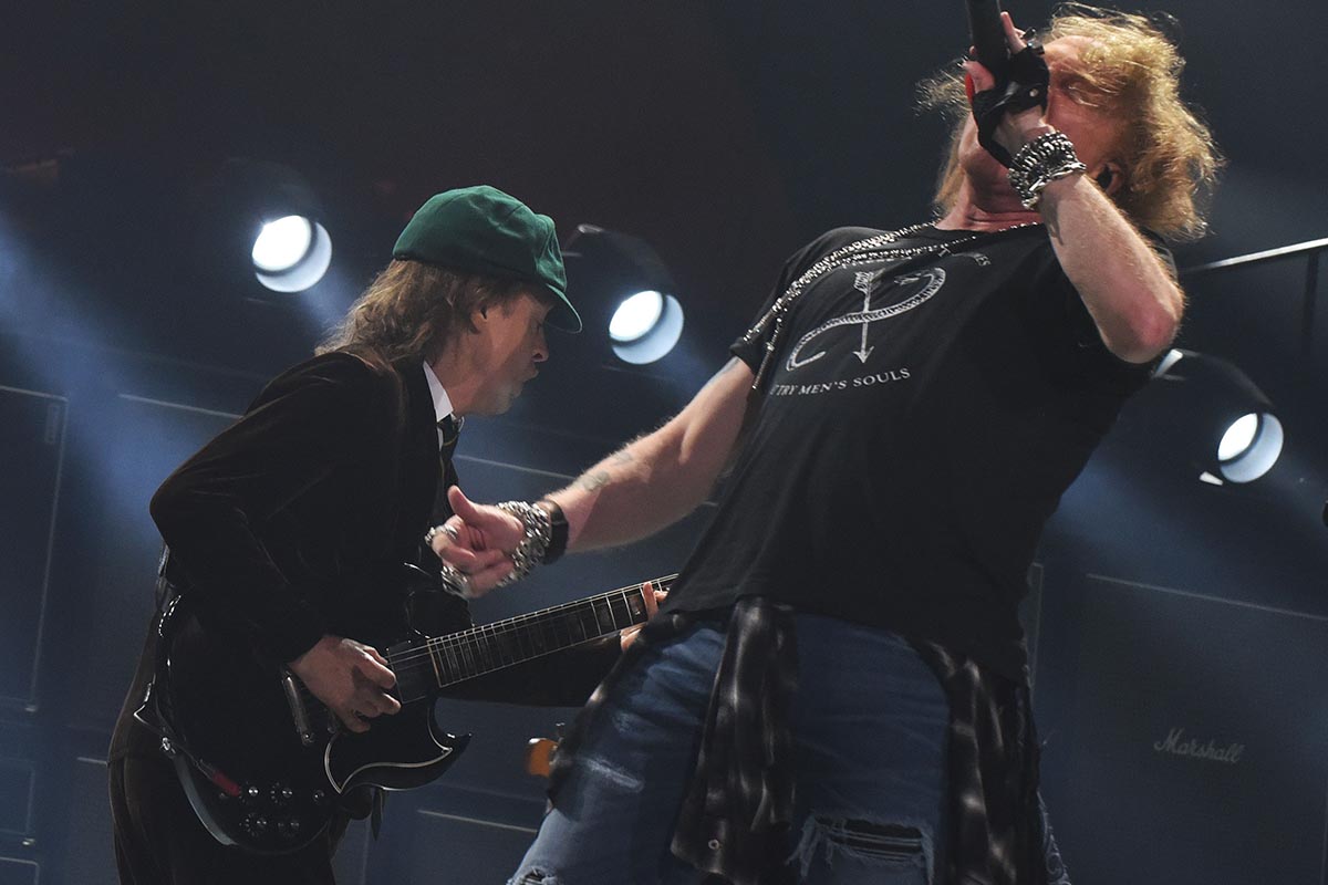 Angus Young and Axl Rose of AC/DC perform at Philips Arena on September 1, 2016 in Atlanta, Georgia. AC/DC has the most popular band tee, according to a survey of music fans from Rush Order Tees.