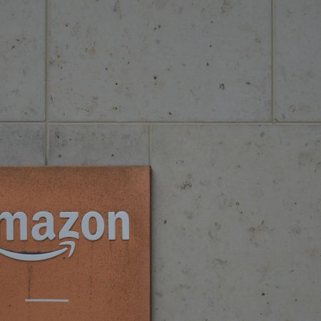 Amazon logo on the side of a building. A new investigation from The Wall Street Journal found some Amazon retailers contacted buyers about bad reviews.