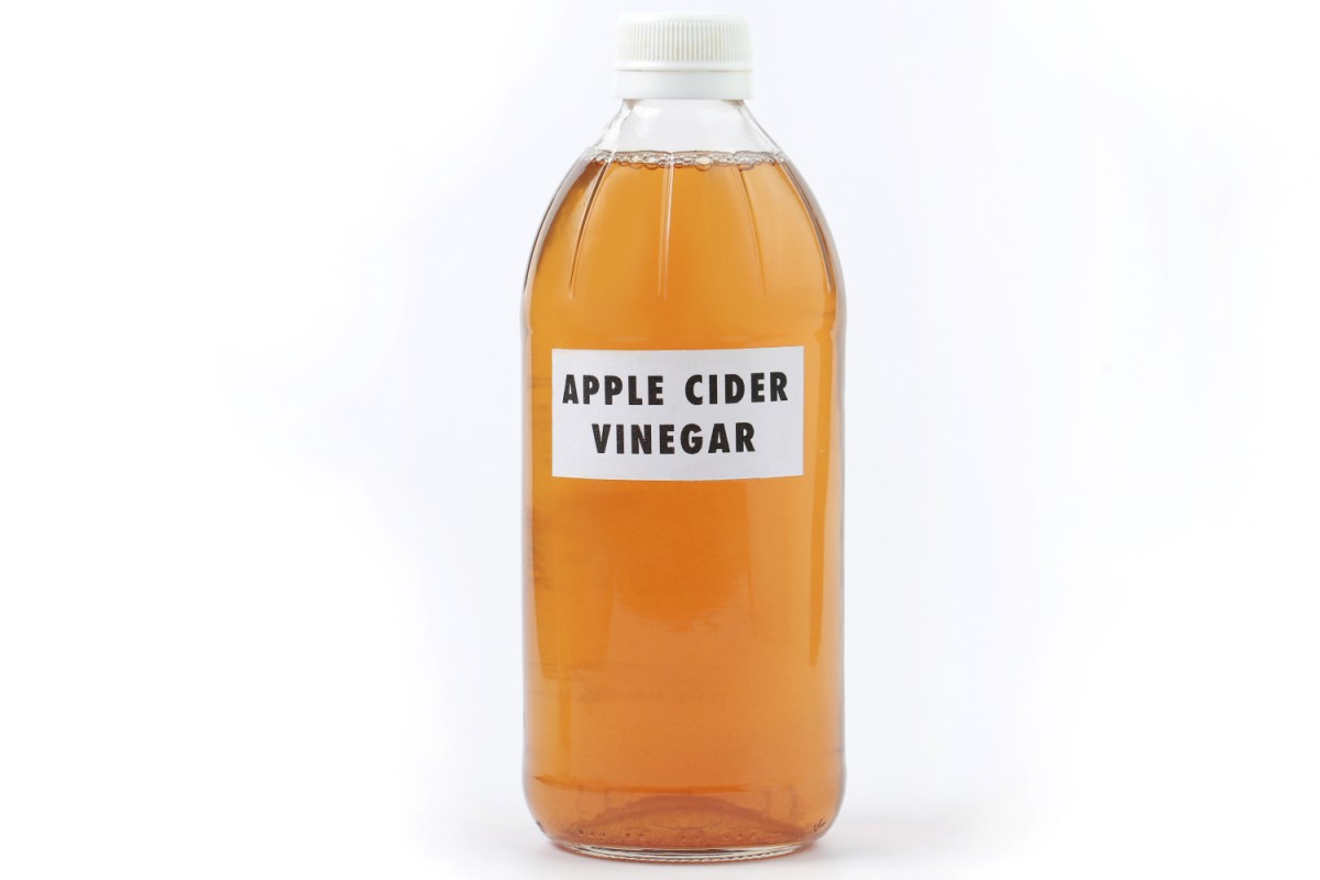 bottle of apple cider vinegar on white background