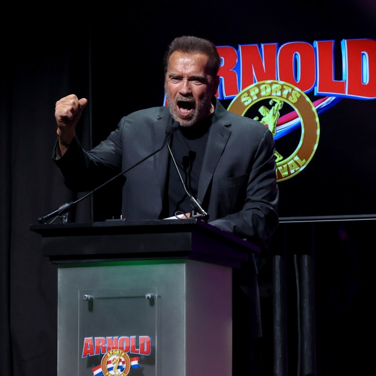 Arnold Schwarzenegger addresses crowd at podium