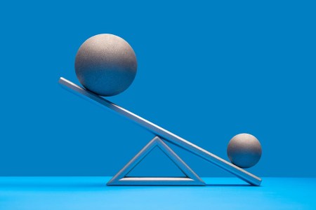 With little evidence, some people believe a certain probiotic can increase testicle size.Pictured: One large and one smaller silver ball on seesaw weight scale, larger ball on high side, blue surface and background
