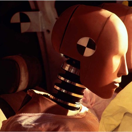 Crash-test dummies inside car with inflated airbags, close-up. Women are more likely to be hurt than men in car crashes due to poor design from government agencies who use crash test dummies.