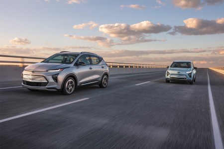 A Chevrolet Bolt EUV and Chevrolet Bolt EV driving down the highway. GM recalled all model years of the electric vehicles after risk of battery fires.