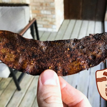 Holding up a crispy piece of banana peel bacon. The fake meat recipe went viral, but is it any good?