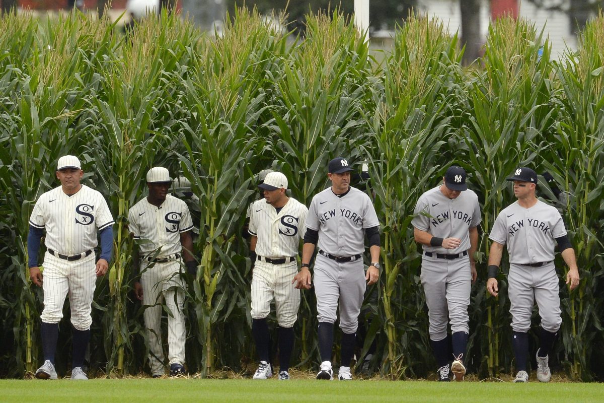 Players walk though the corn rows at the Field of Dreams game in Iowa.