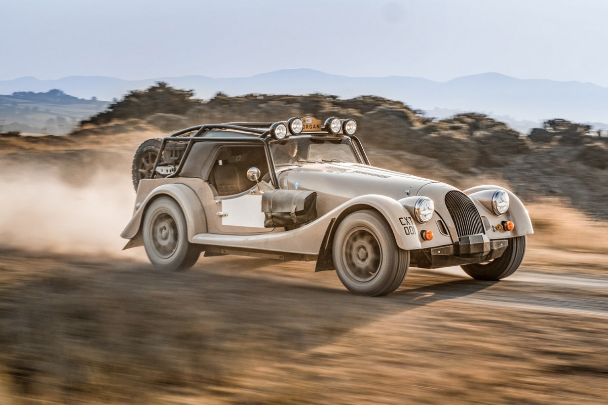 The new Morgan Plus Four CX-T driving on an off-road trail. The new limited-edition sports car from Morgan Motor Company was built in partnership with Rally Raid UK.