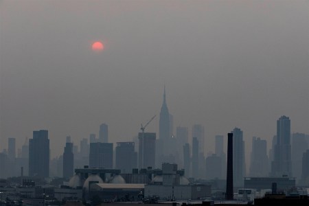 Manhattan skyline and a red sun is seen in a thick haze in New York, the United State, July 20