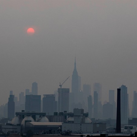 Manhattan skyline and a red sun is seen in a thick haze in New York, the United State, July 20