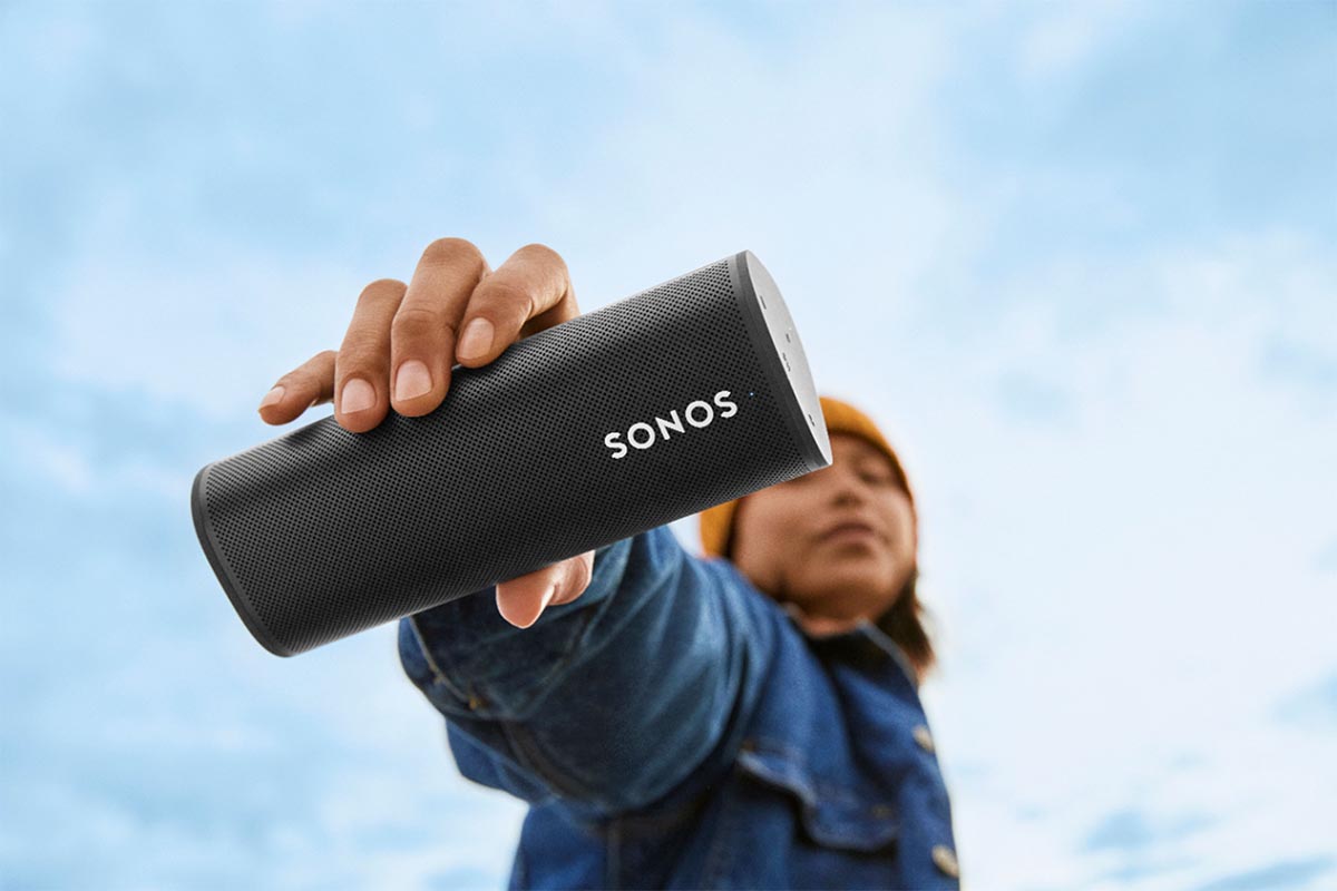 A person holding the Sonos Roam speaker up outside. The portable speaker is nearly $60 off at Best Buy.