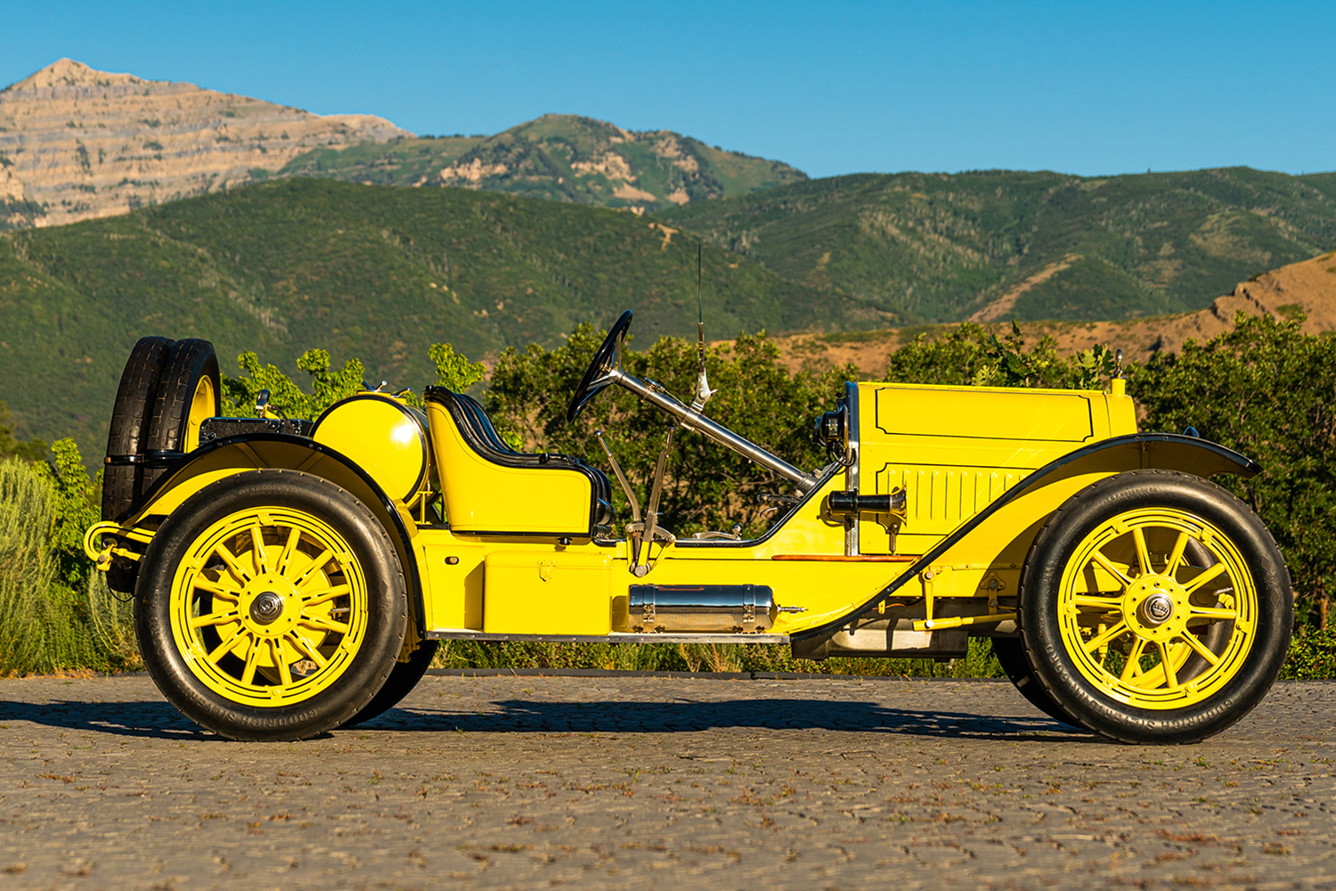 The profile of a yellow and black 1914 Stutz Bearcat, one of the original American sports cars, which will hit the auction block at Pebble Beach via Gooding & Company