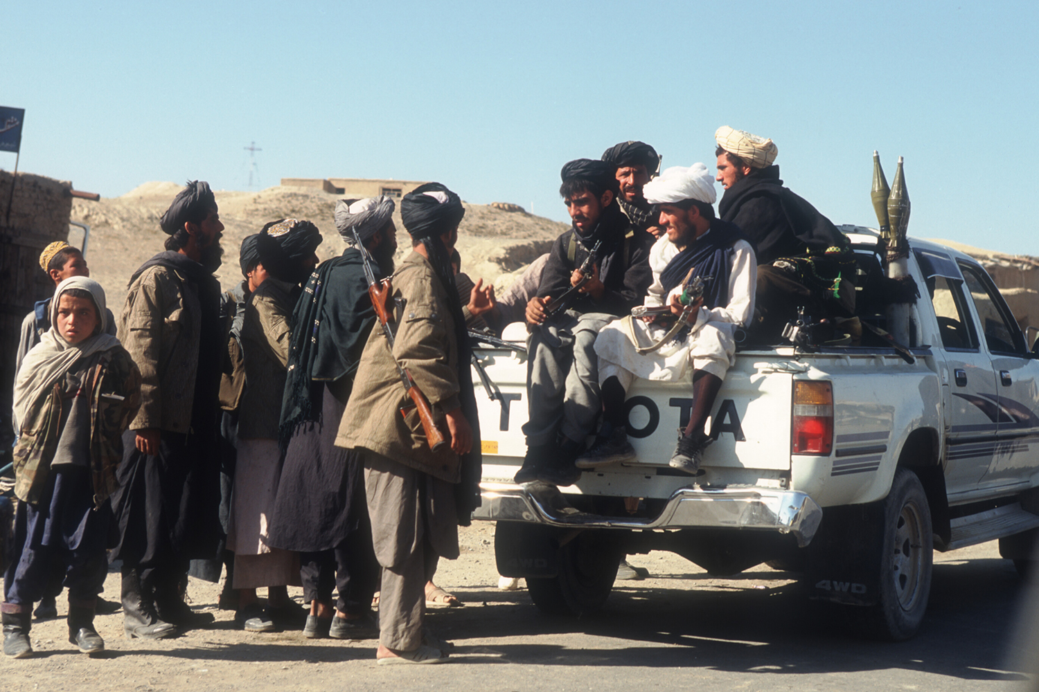 Taliban rebels with a Toyota pickup truck near Bagram Air Base on October 18, 1996. The Islamic group has a history of fighting with Toyota pickup trucks and SUVs, highlighted by their Afghanistan takeover in August 2021.
