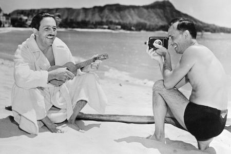 Walt and Roy Disney on the beach in a black and white photo. The brothers' first house in Los Angeles is undergoing a restoration.