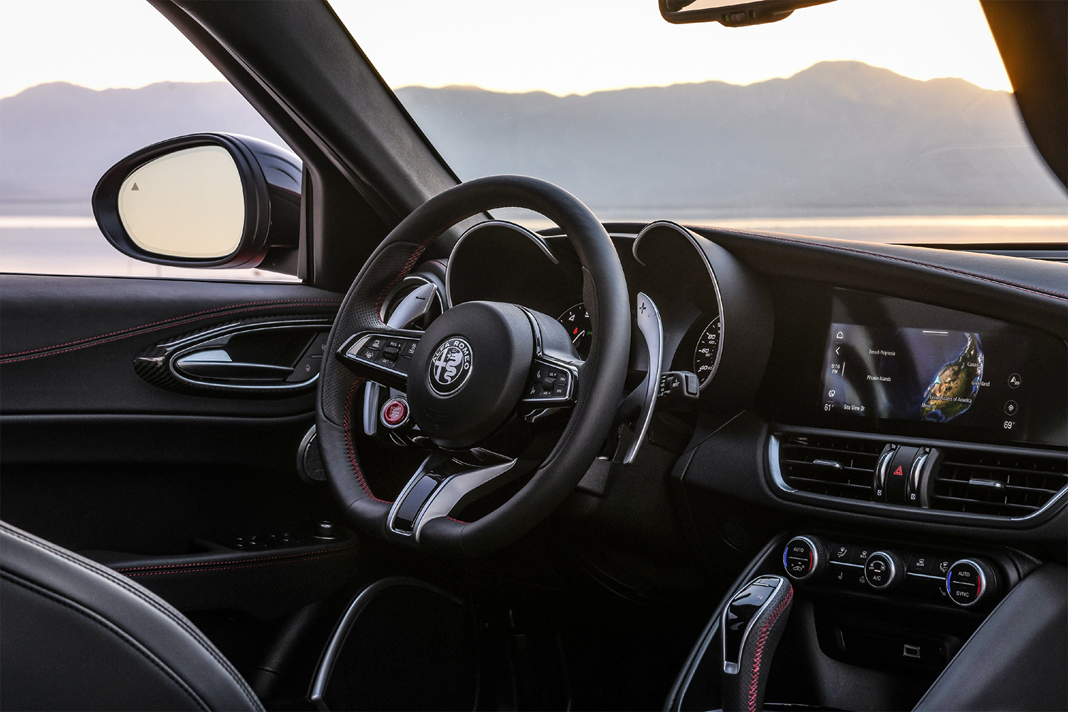The interior of the 2021 Alfa Romeo Giulia Quadrifoglio, including the steering wheel, shifter and dashboard