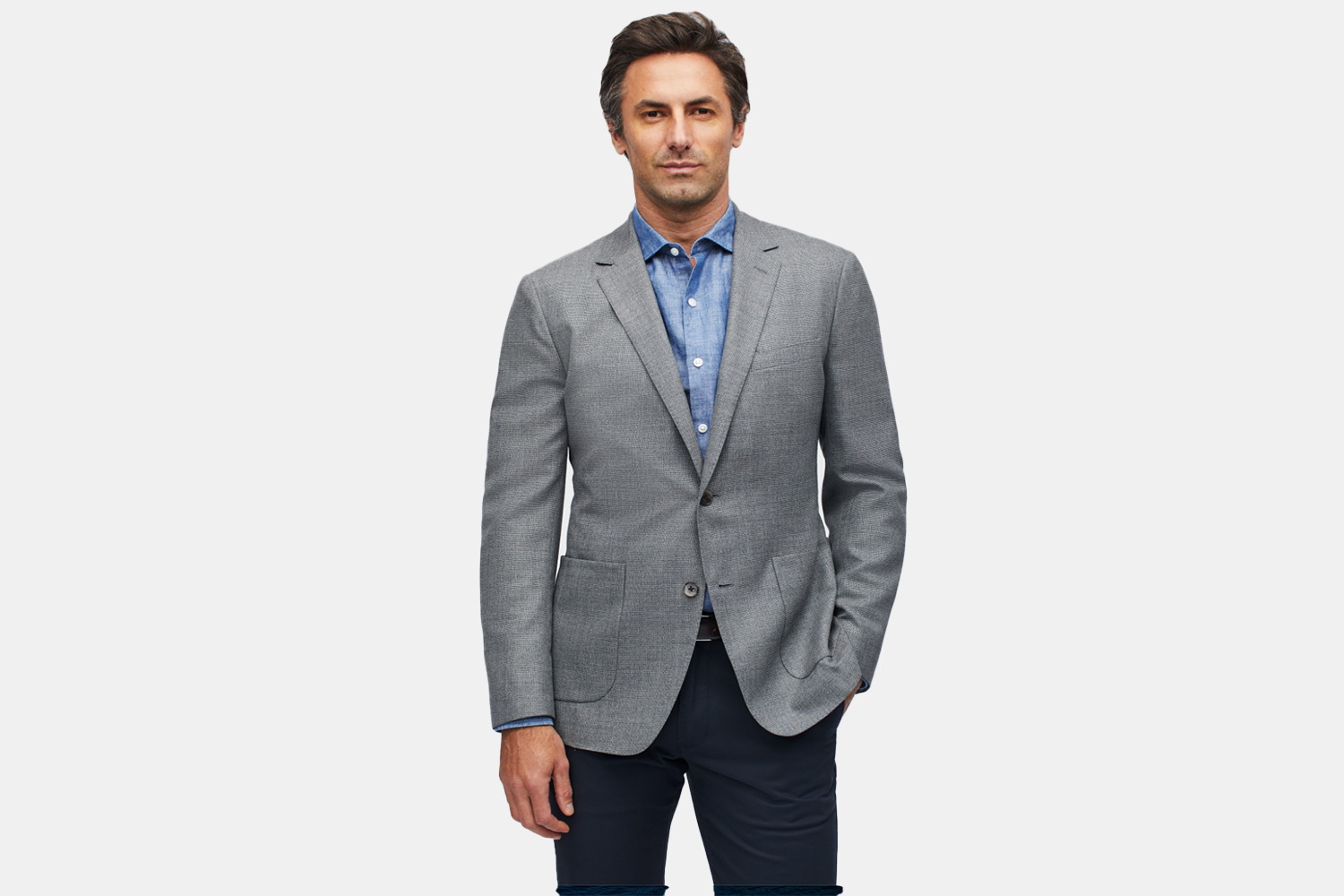 a man in a grey suit jacket