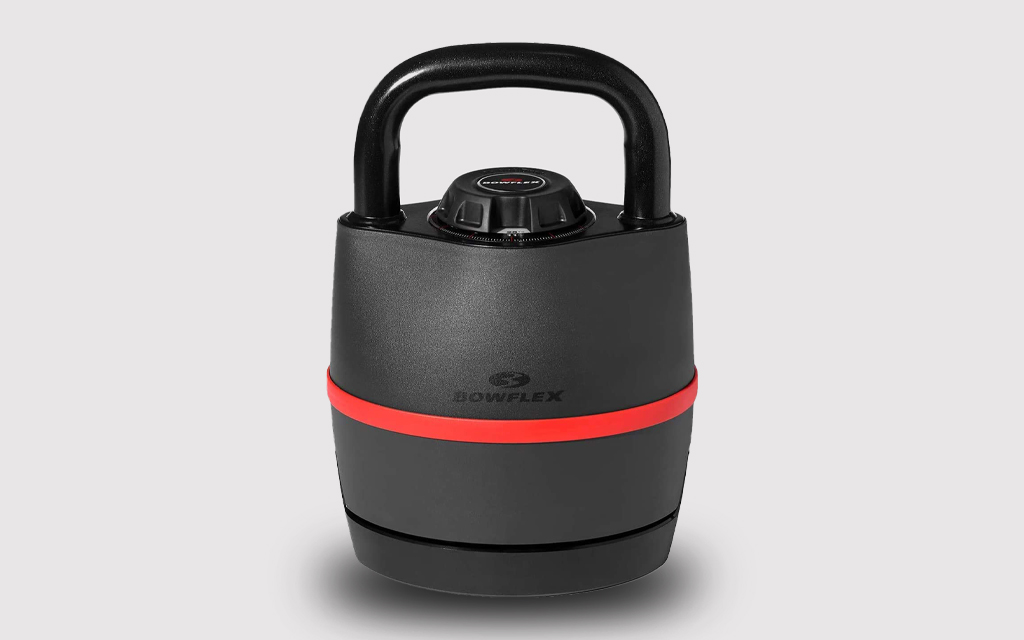 An adjustable kettlebell from Bowflex in red and black on a grey background. The workout equipment is on sale on Amazon.