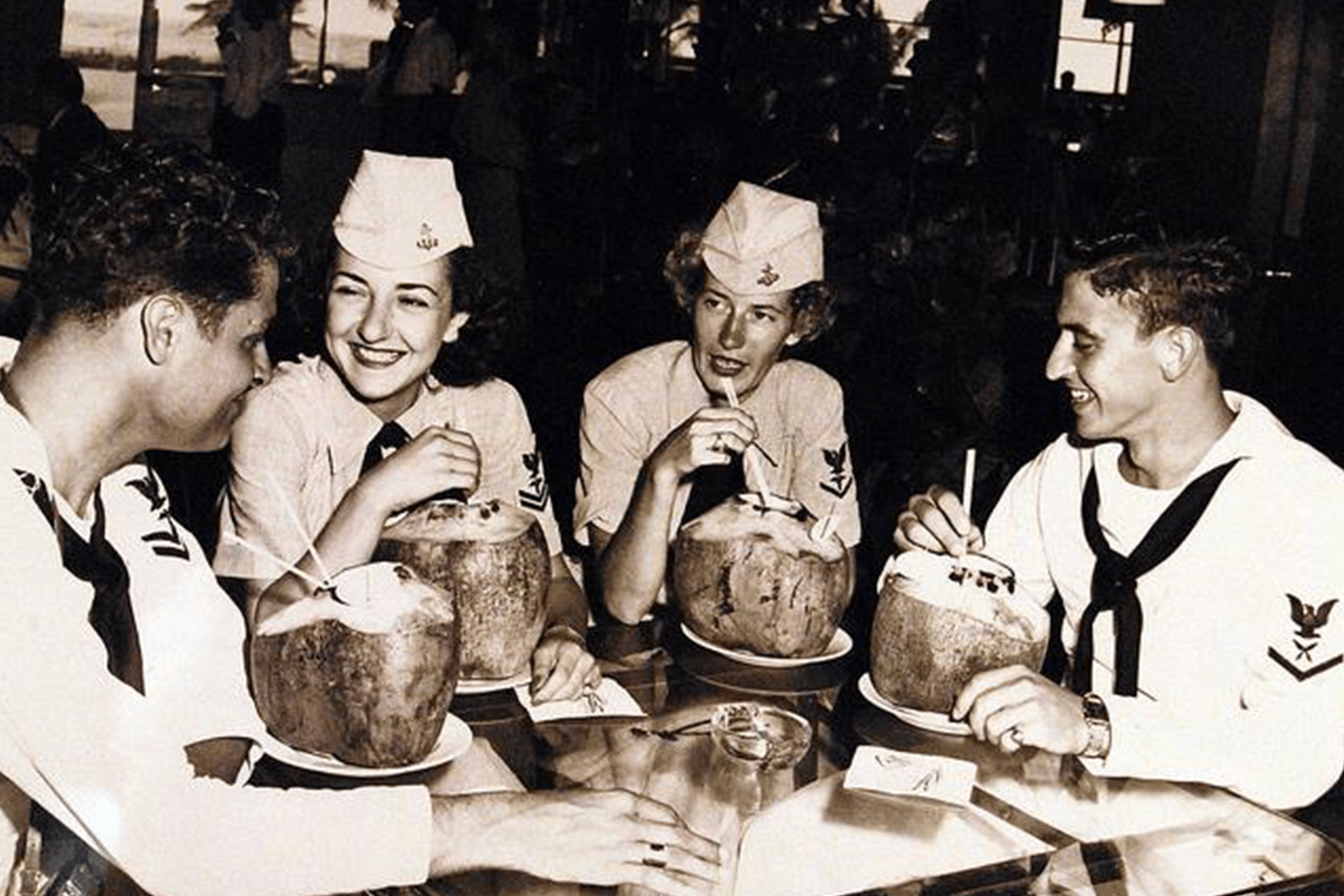 US Navy servicemen and women drinking piña coladas at the Caribe Hilton, c. 1953
