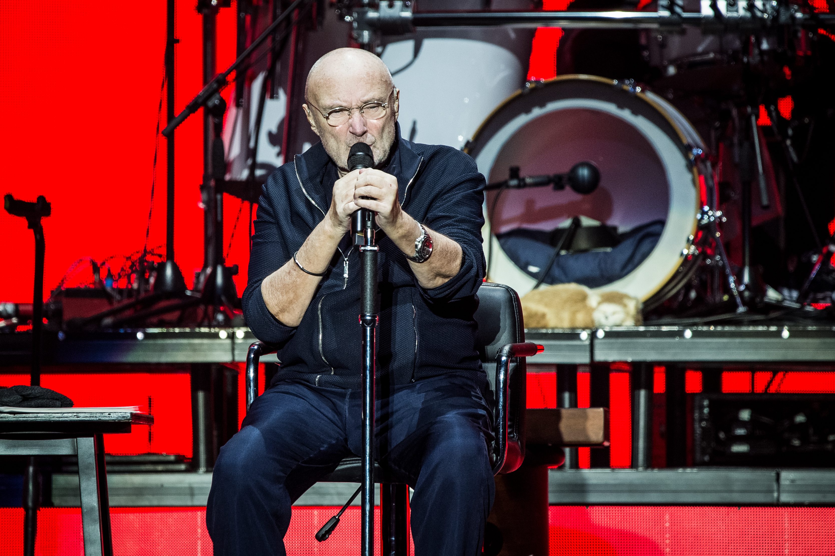 Phil Collins performs live on stage for the Italian date of his Still Not Dead Yet Live tour 2019. He currently cannot drum and sits during his concert performances.