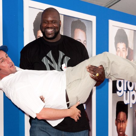 Shaquille O'Neal holding Adam Sandler in his arms like a baby at the premiere of "Grown Ups 2" on July 10, 2013 in New York City
