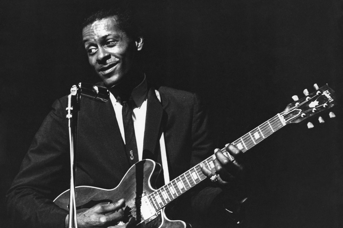 Chuck Berry performs onstage with his Gibson hollowbody electric guitar circa 1965.