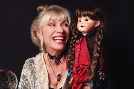 hollywood with patti negri holds a porcelain doll with braided hair