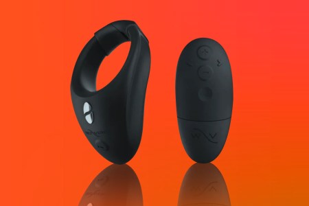 We-Vibe Bond sex toy and remote on hot orange background