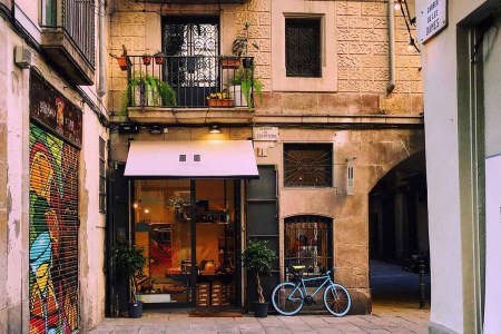 A small store, apartment and a bicycle in Barcelona, a city that has started to crack down on Airbnb listings