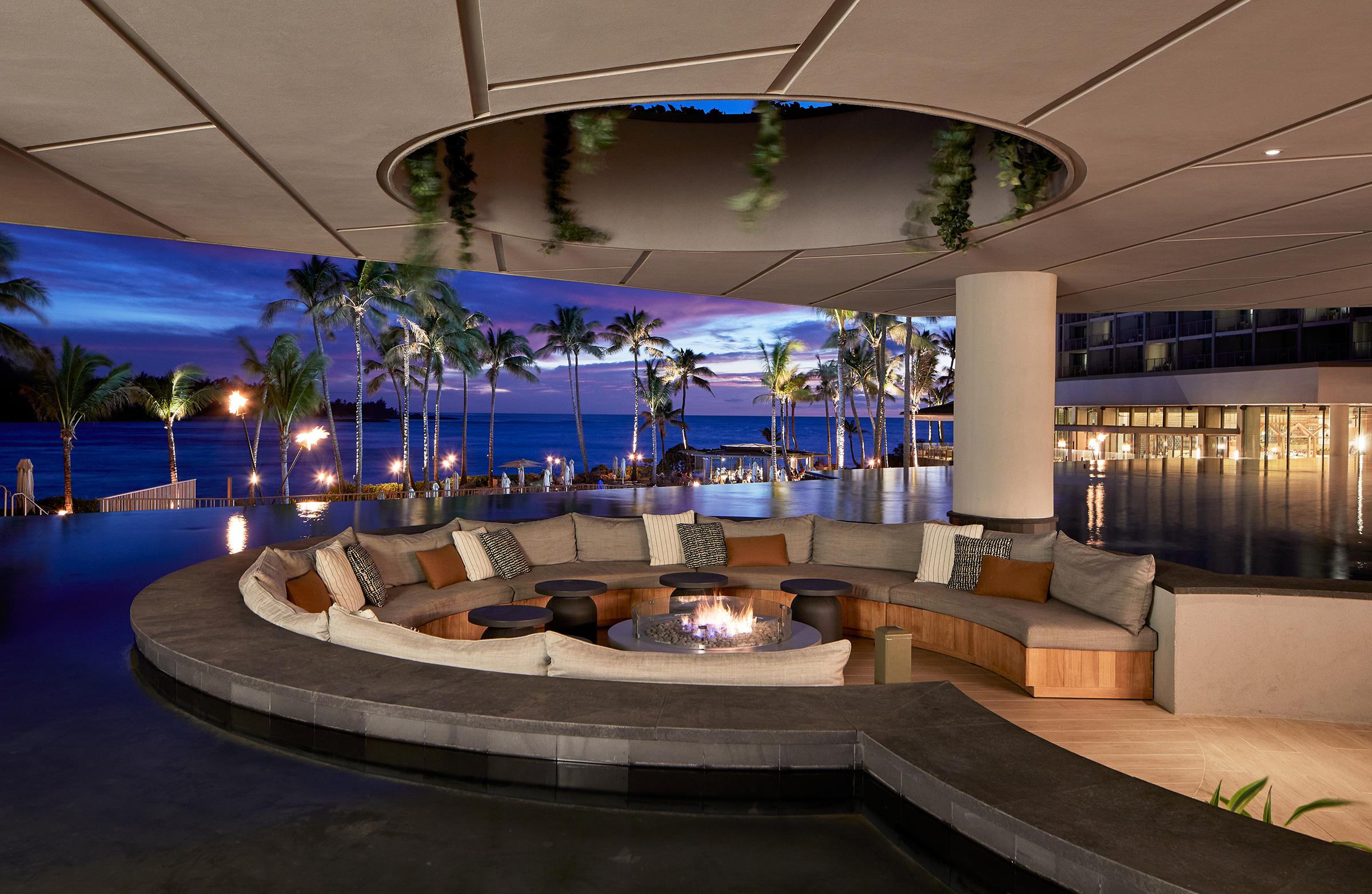 a fire pit and cushioned seating at the Off the Lip lobby bar at the Turtle Bay Resort in Oahu