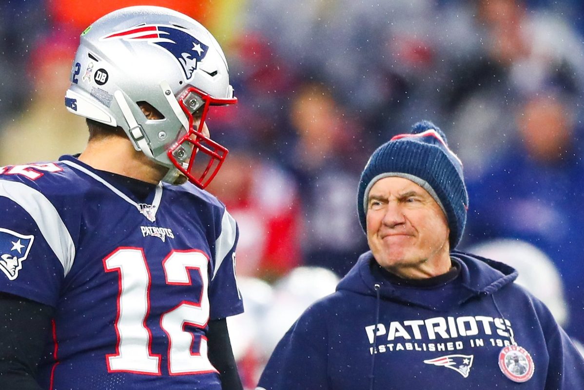 Tom Brady talks to Bill Belichick before a game in 2019